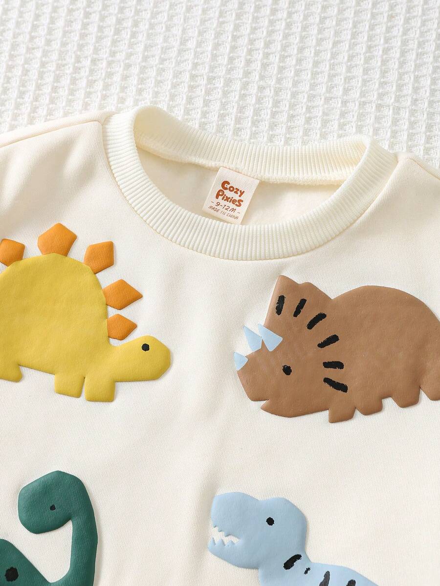 SHEIN Cozy Pixies بلوزة أطفال بياقة طاقم وأكمام طويلة بنمط ديناصور كرتوني