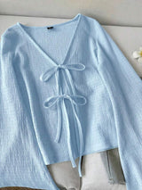 SHEIN LUNE بلوزة كاجوال بأكمام واسعة وربطات على الأساور