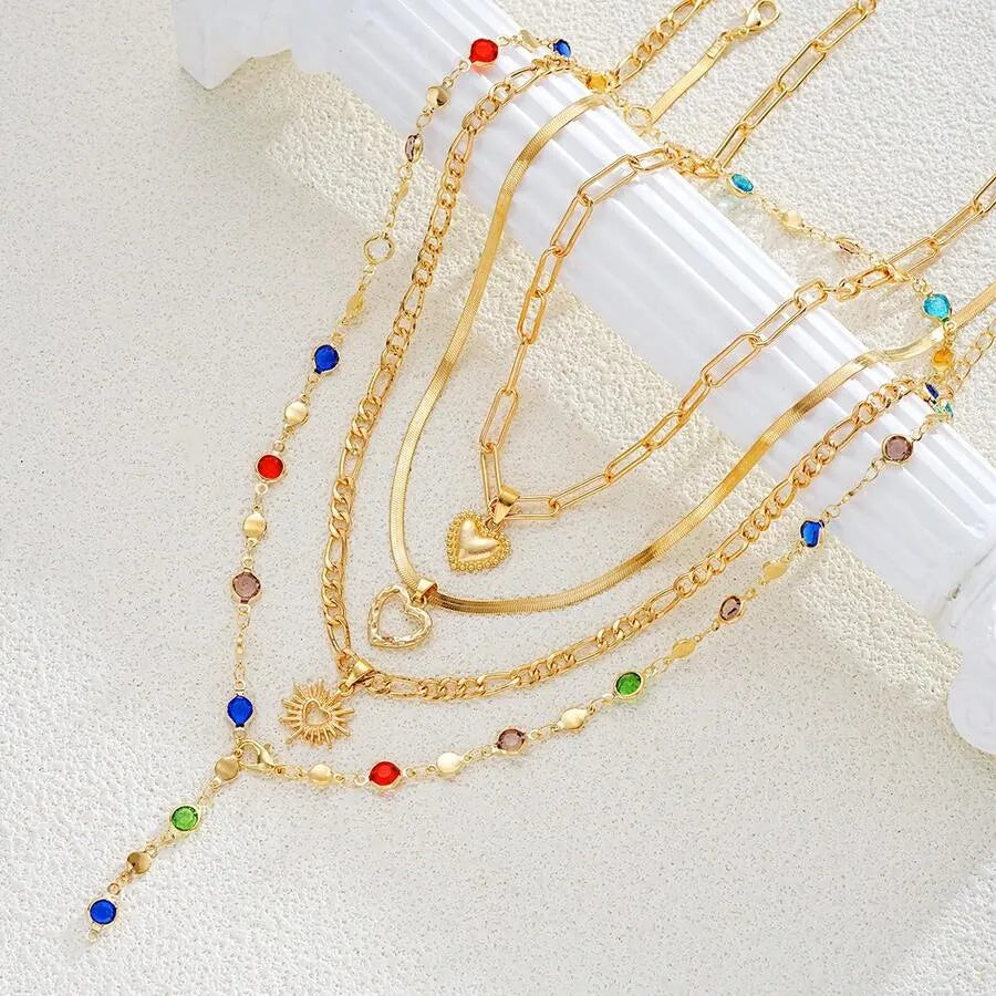SHEIN قلادات متعددة الطبقات بشكل قلب ذهبي وراين ملون 4 قطع